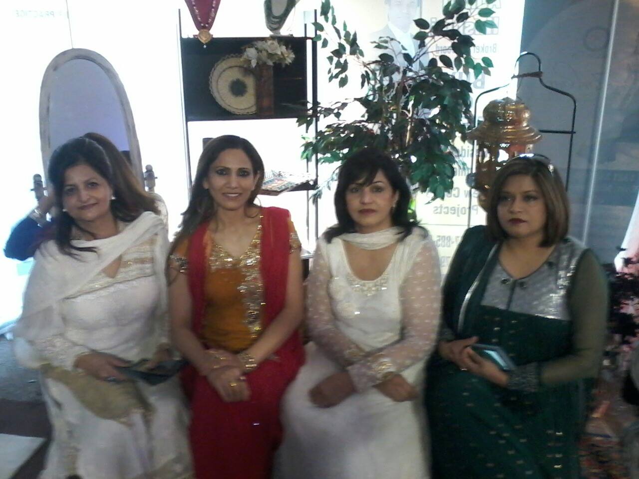 Gul with colleagues at a community cultural event in traditional attire