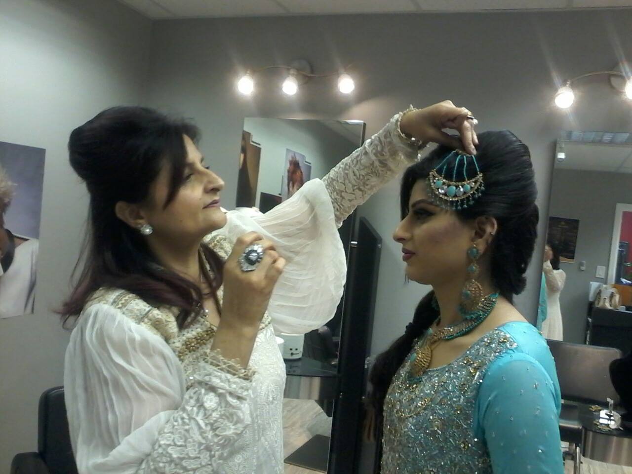 Gul styling an elaborate bridal updo at Hair Care Studios